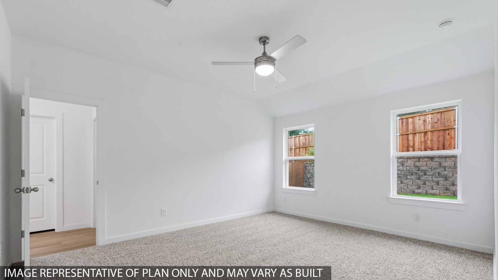 Primary bedroom with carpet flooring