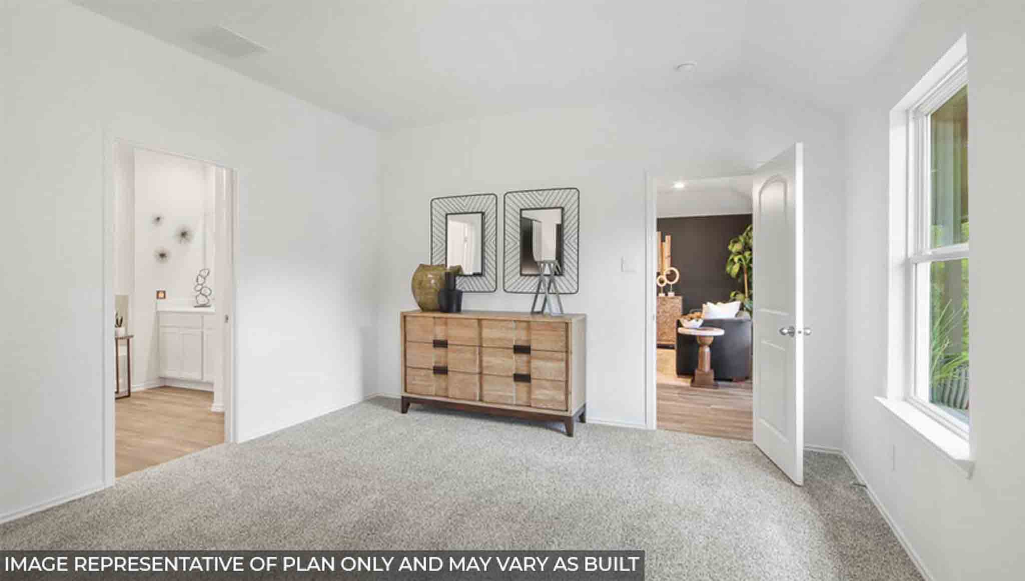 Primary bedroom with bright windows