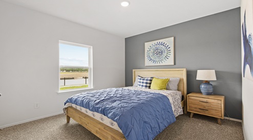 Secondary bedroom with carpet flooring