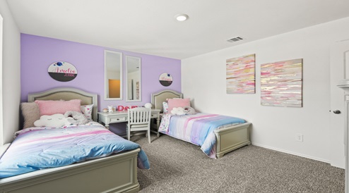 Secondary bedroom with carpet flooring