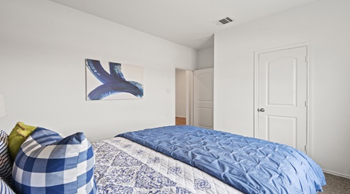 Secondary bedroom with carpet flooring
