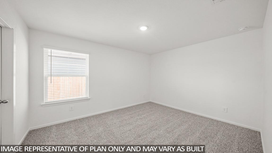 Secondary bedroom with carpet flooring