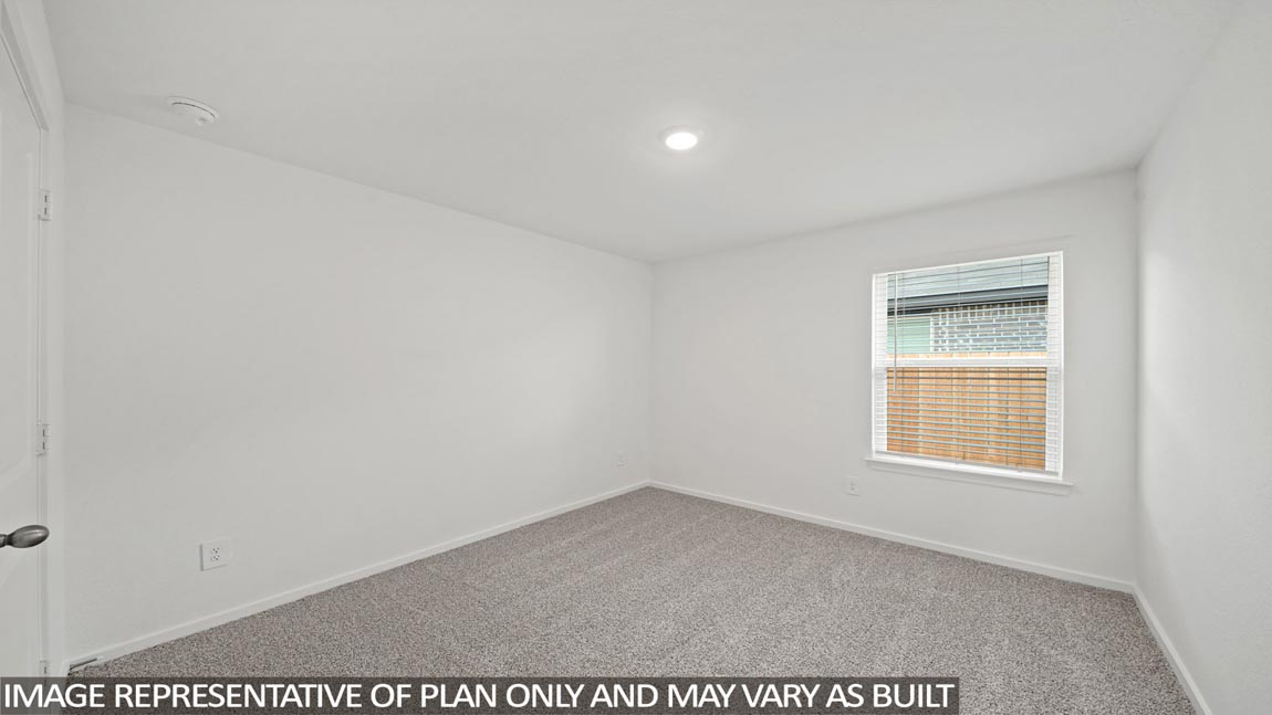 Secondary bedroom with carpet flooring
