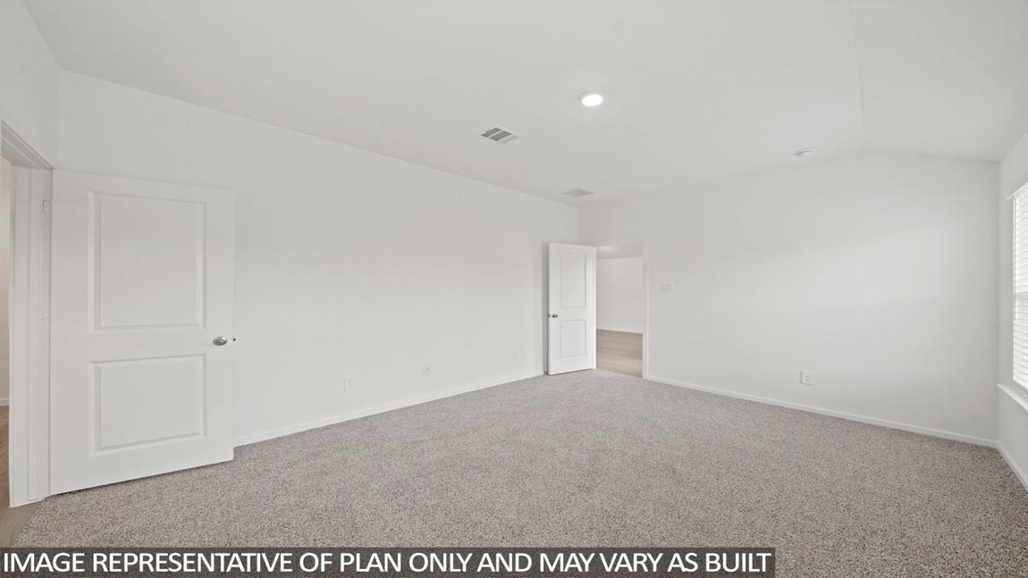 Primary bedroom with carpet flooring