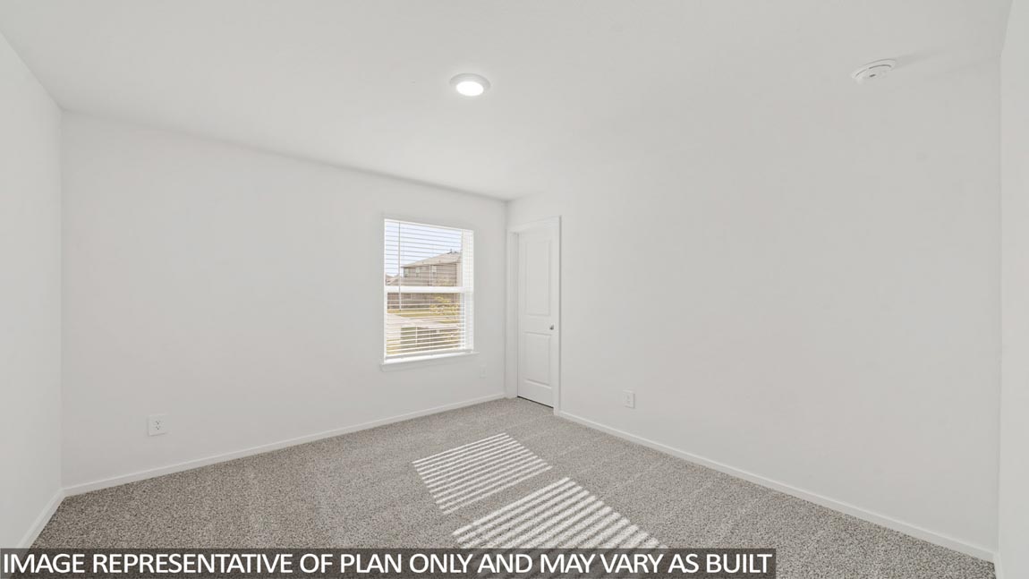 Secondary bedroom with carpet flooring