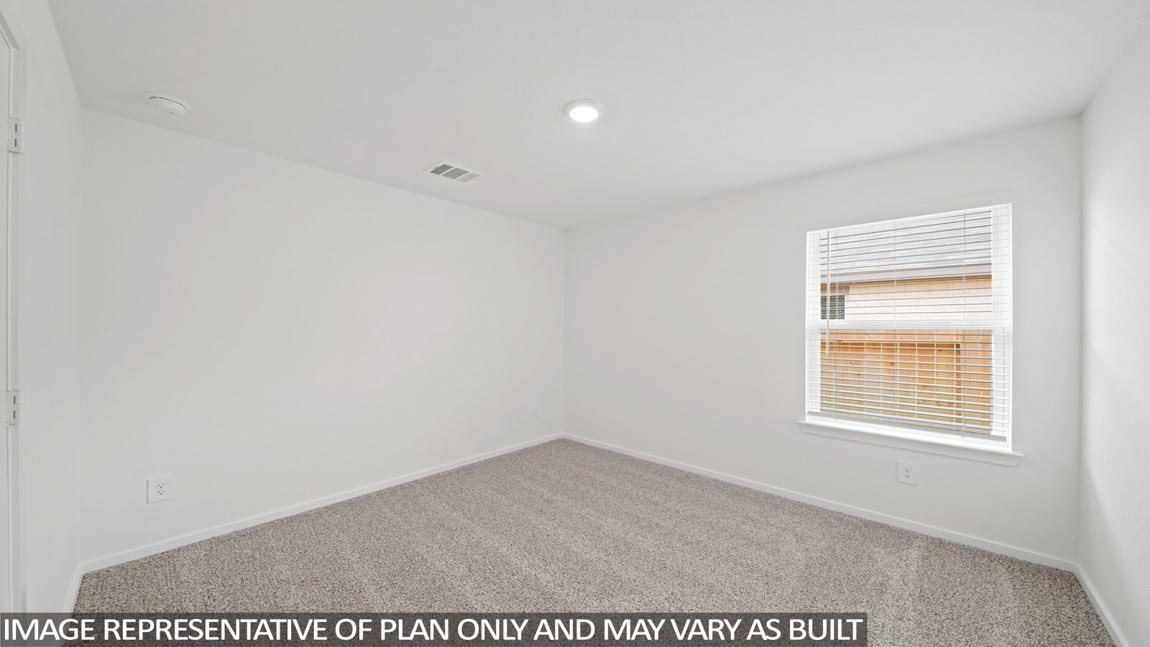 Primary bedroom with carpet flooring