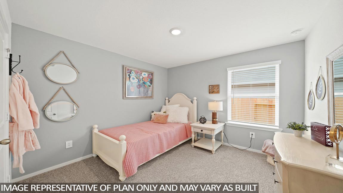 Secondary bedroom with carpet flooring