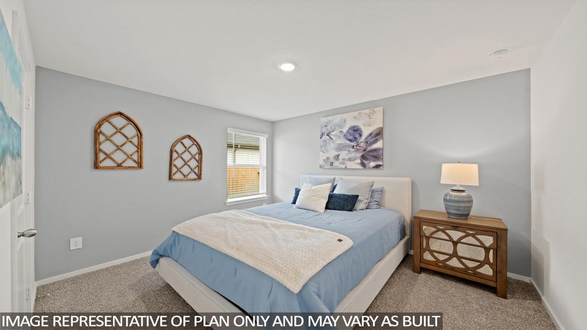 Secondary bedroom with carpet flooring