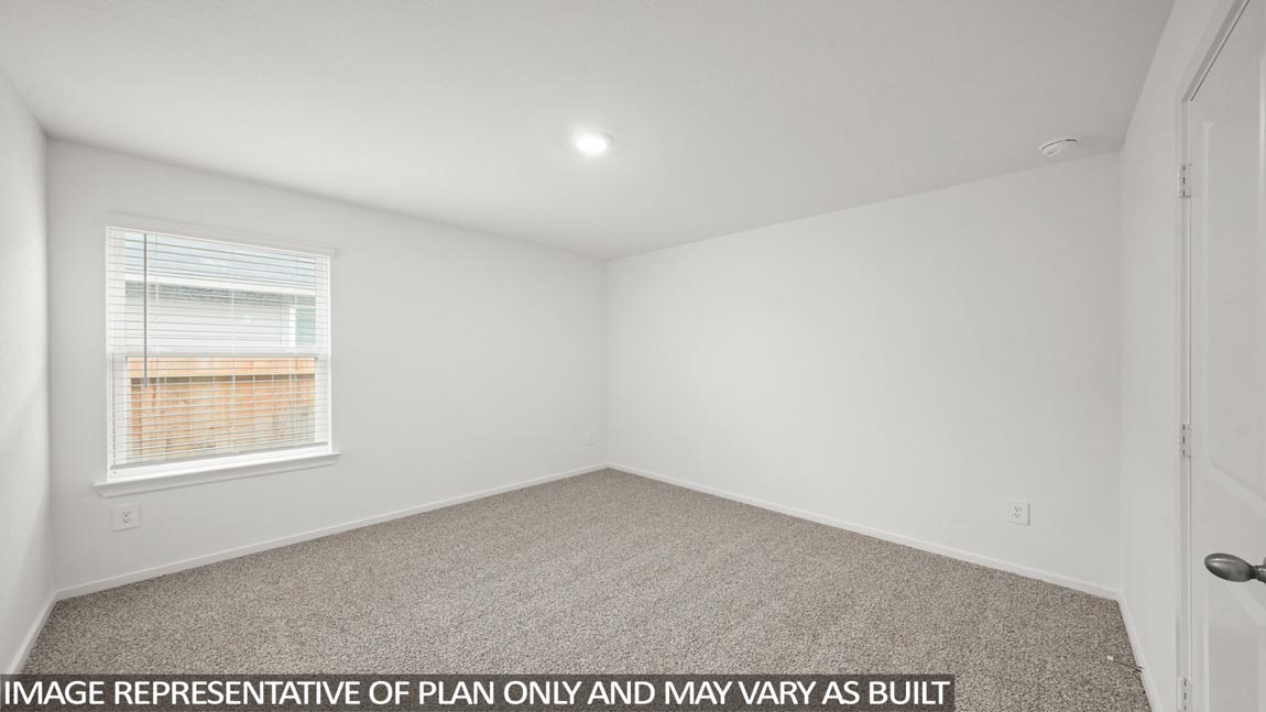 Secondary bedroom with carpet flooring