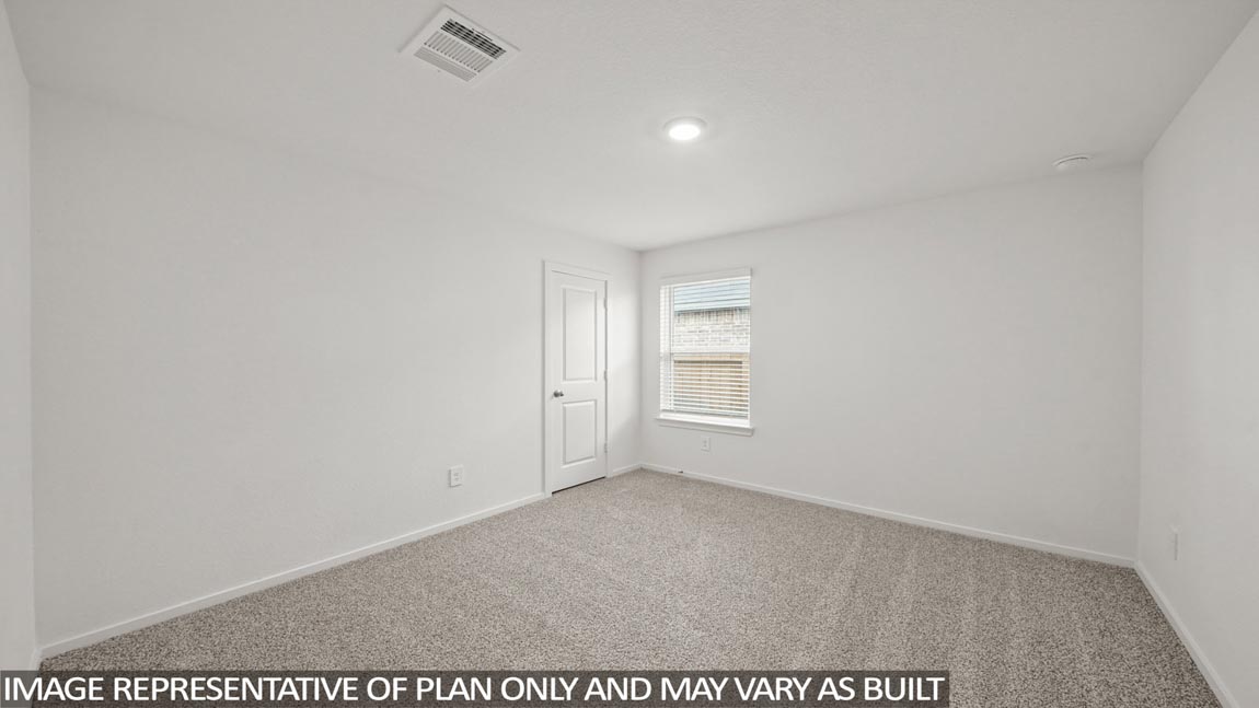 Secondary bedroom with carpet flooring