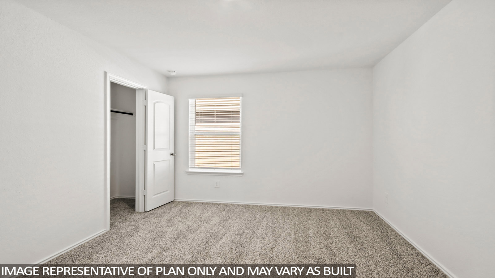Secondary bedroom with carpet flooring