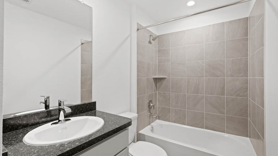 Secondary bathroom with a tile tub.