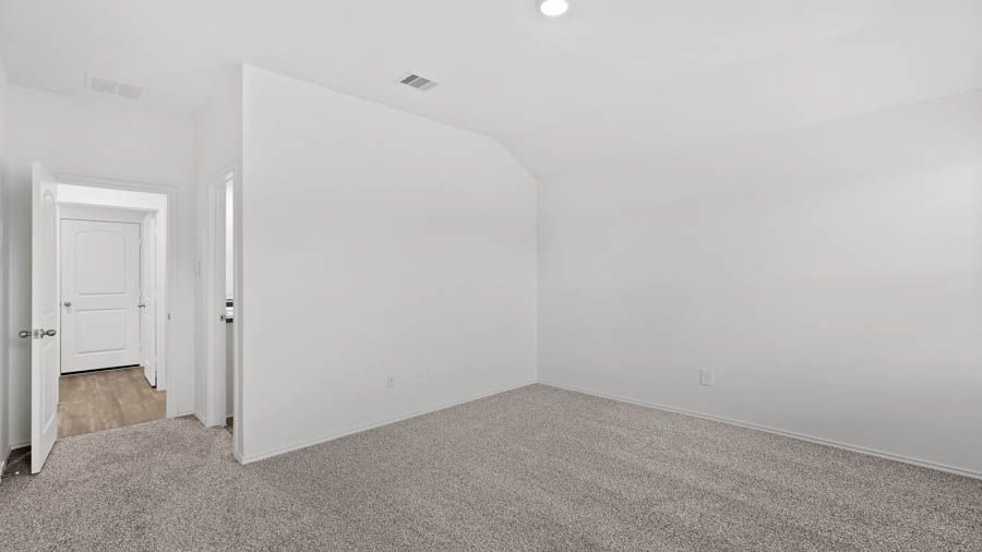 Primary bedroom with carpet flooring.