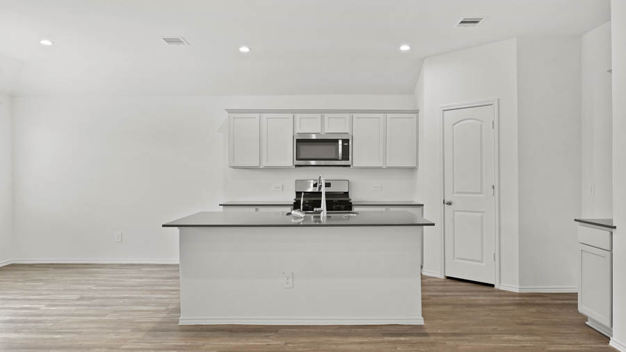 Kitchen with island and stainless-steel appliances.