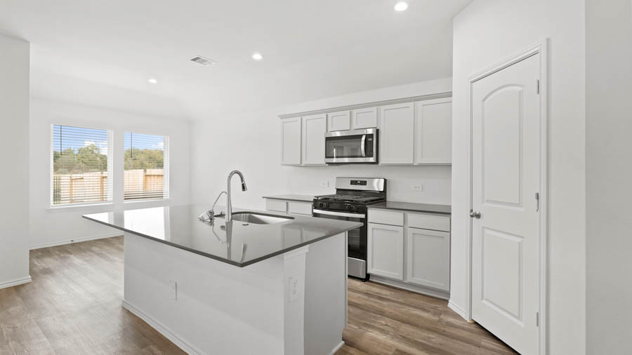 Kitchen with island and stainless-steel appliances.