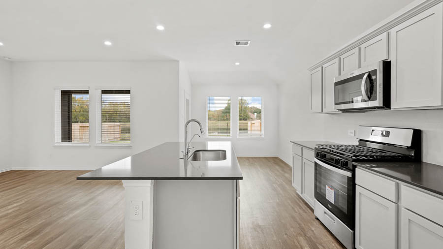 Kitchen with island and stainless-steel appliances.