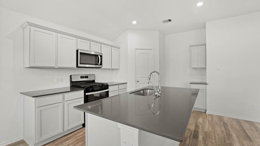 Kitchen with island and stainless-steel appliances.