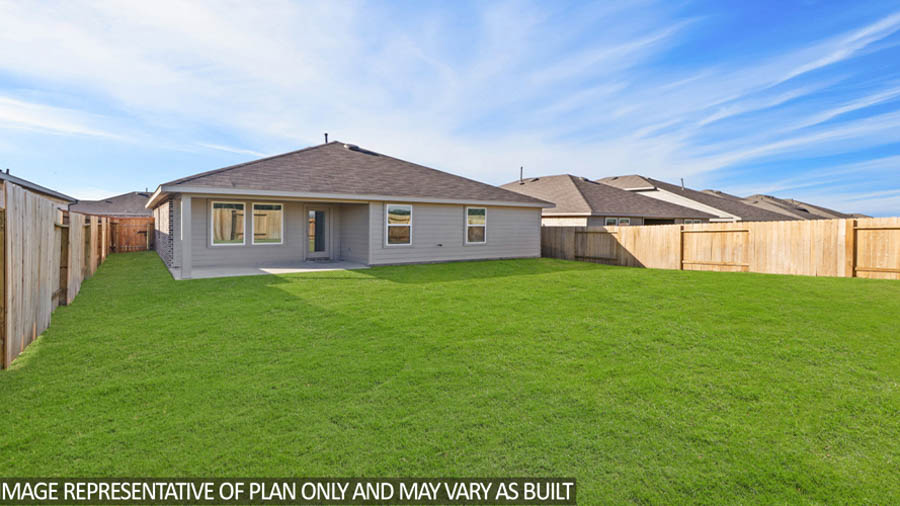 Spacious backyard with patio.