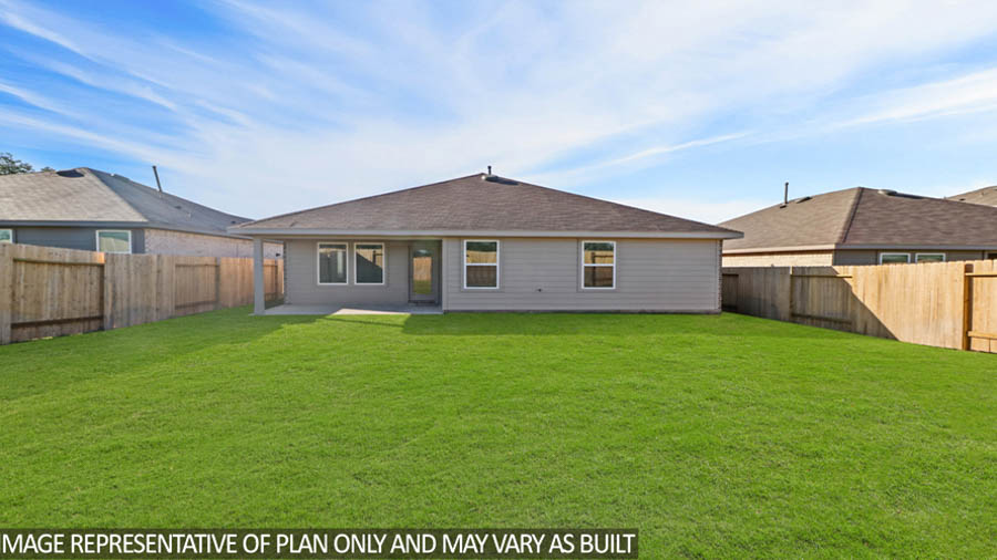 Spacious backyard with patio.