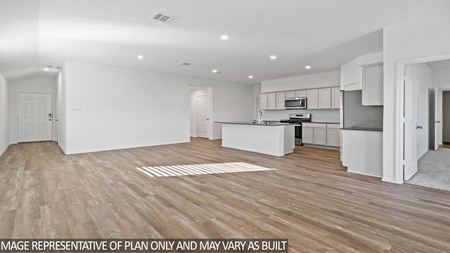 Open concept living and dining space with vinyl flooring.