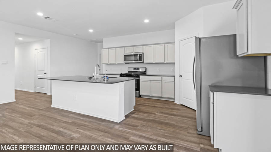 Kitchen with island and stainless-steel appliances.