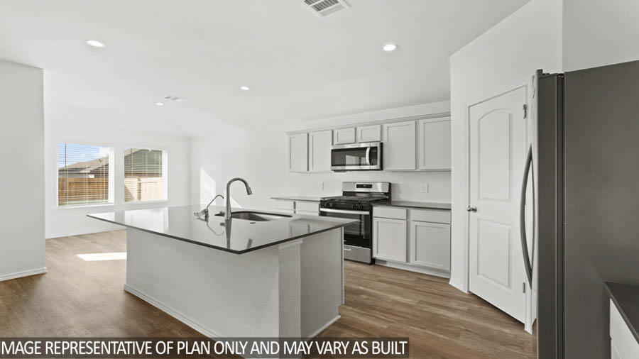 Kitchen with island and stainless-steel appliances.