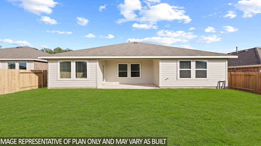 Spacious backyard with patio.