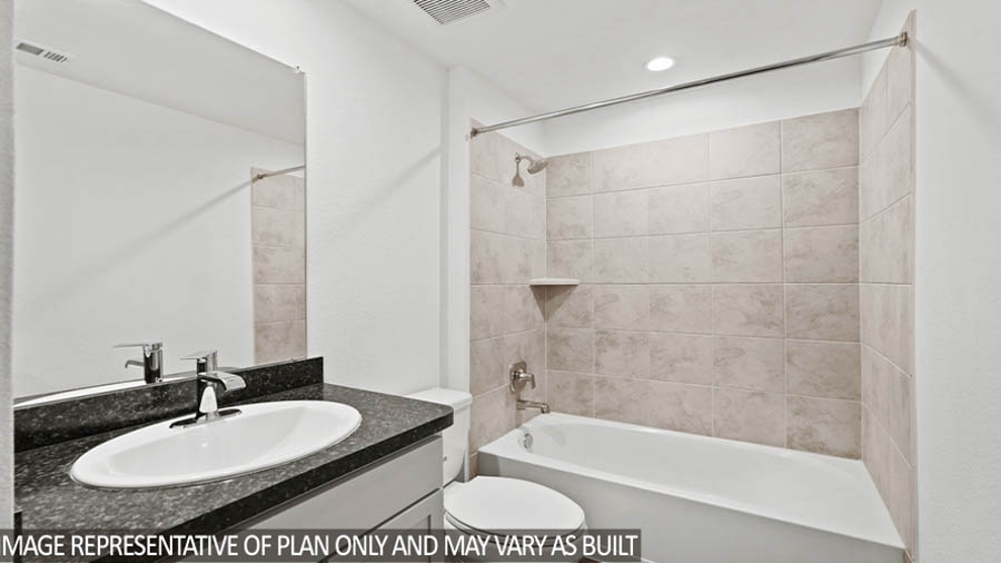Secondary bathroom with a tile tub.