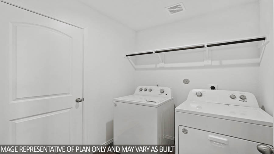 Utility room with overhead storage space.