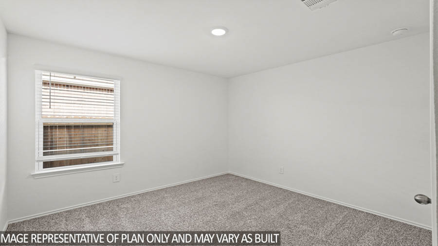 Secondary bedroom with carpet flooring and a bright window.