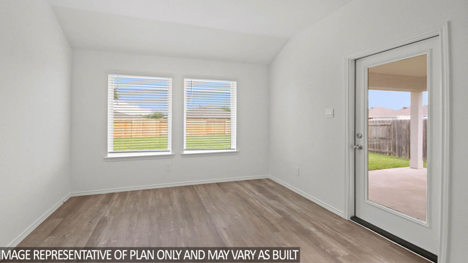 Breakfast nook with vinyl flooring and bright windows.