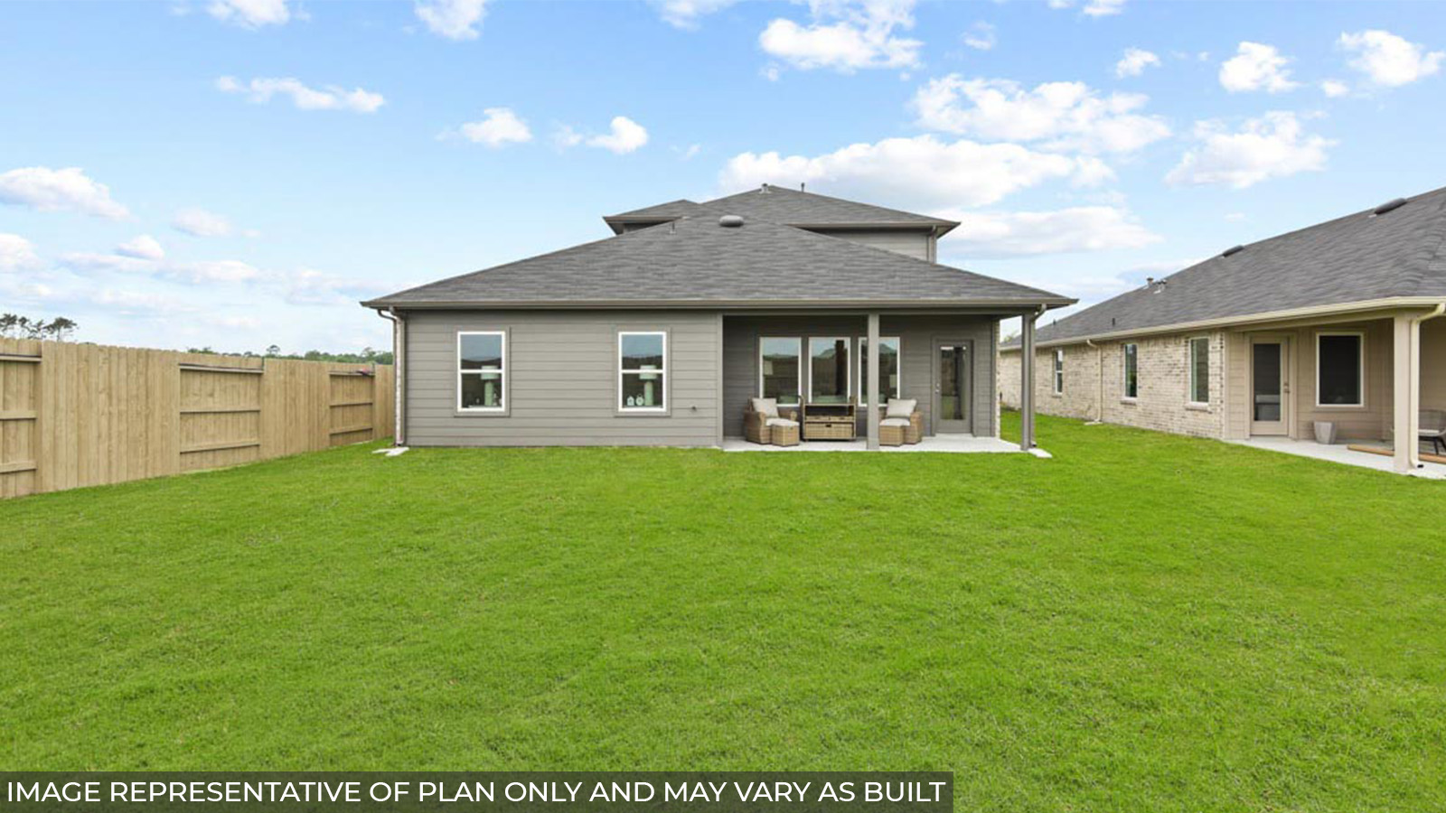 Staged backyard and back patio with an overhead light.