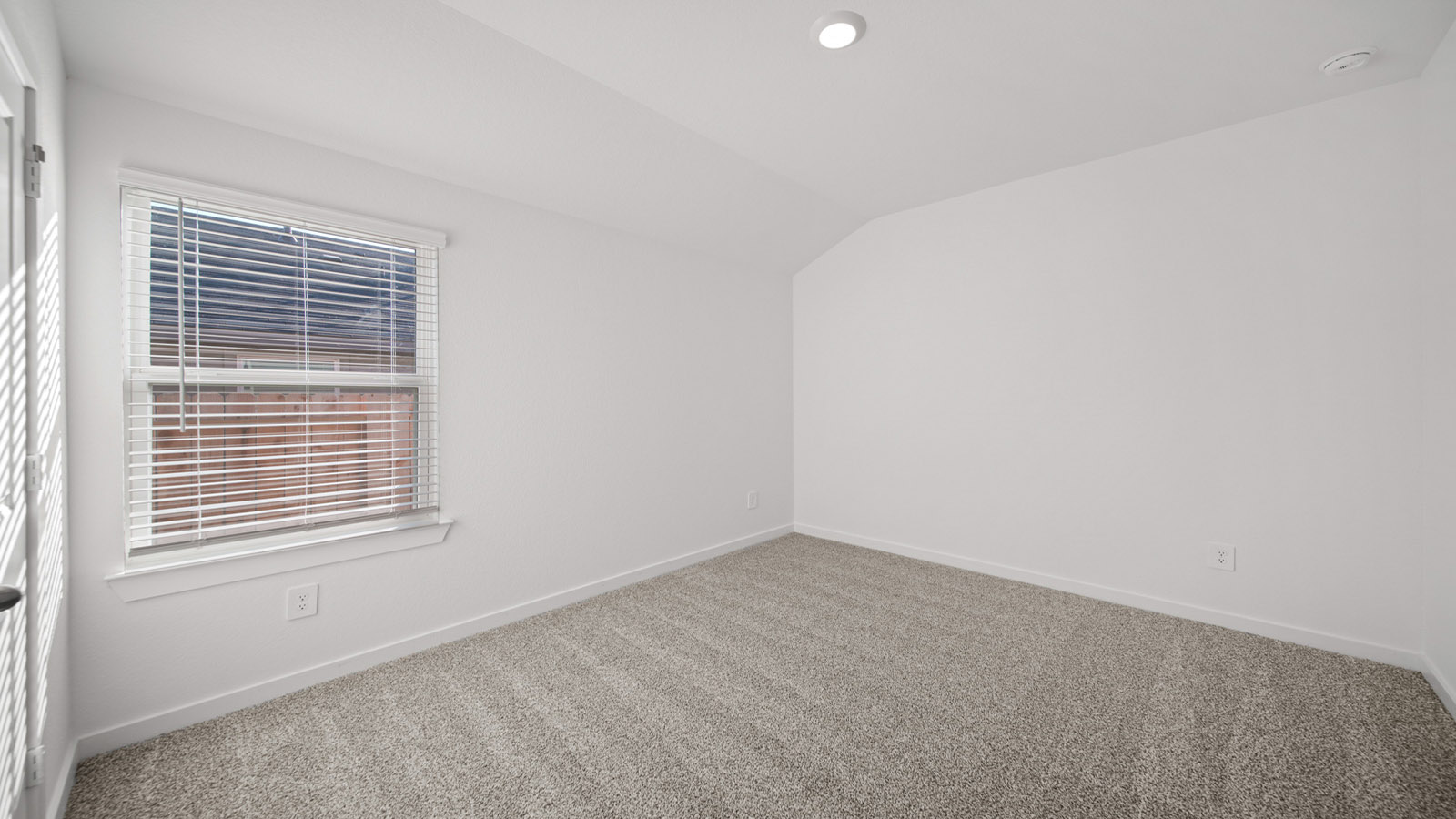 Secondary bedroom with carpet flooring