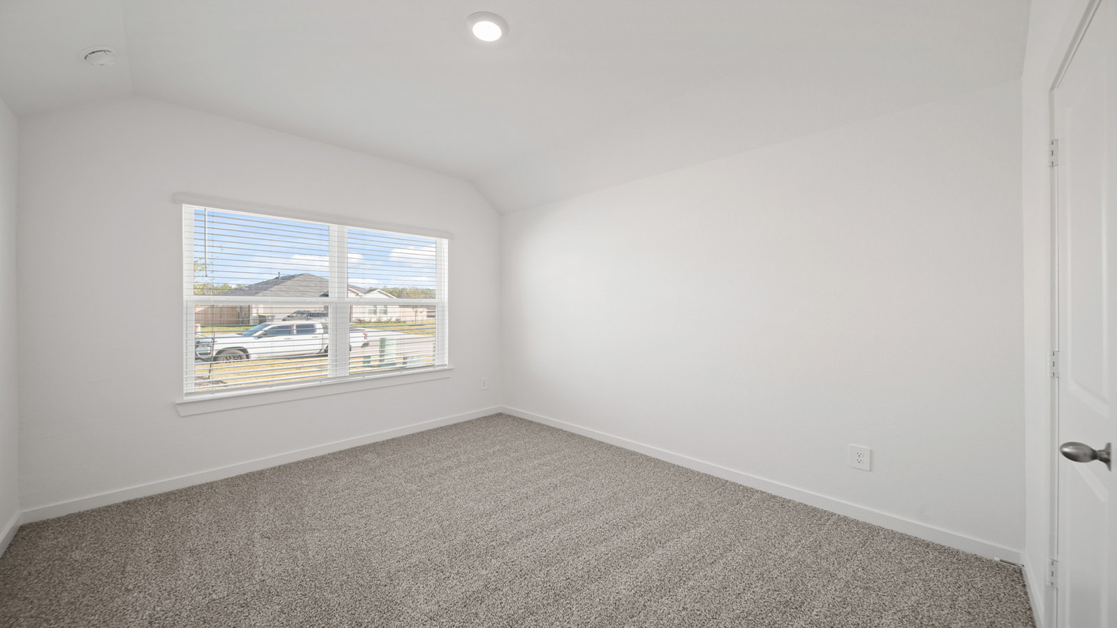 Secondary bedroom with carpet flooring
