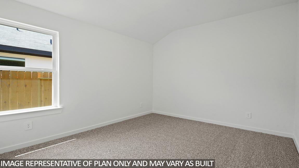 Secondary bedroom with carpet flooring