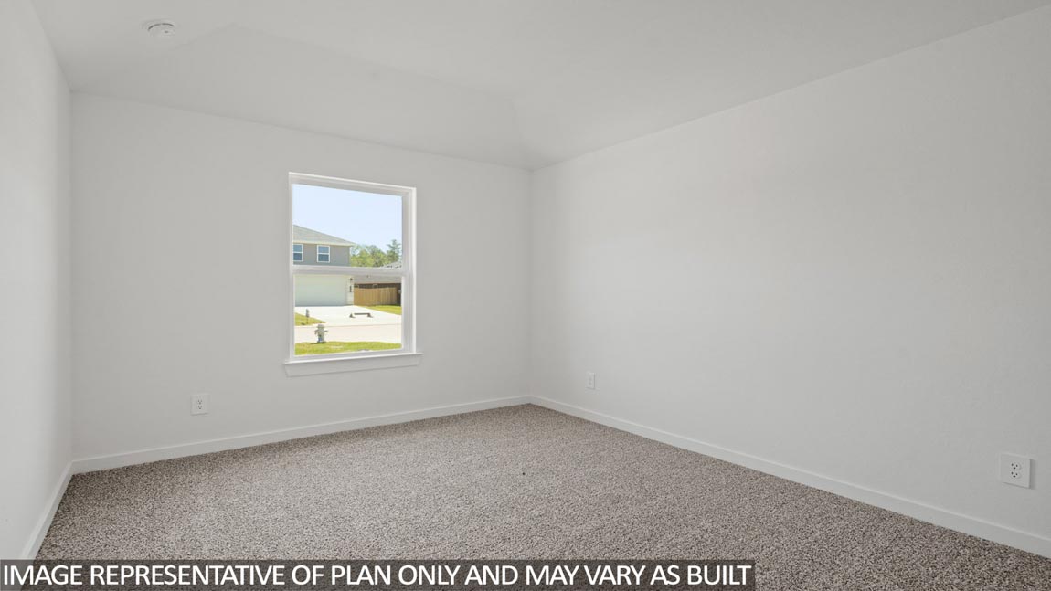 Secondary bedroom with carpet flooring