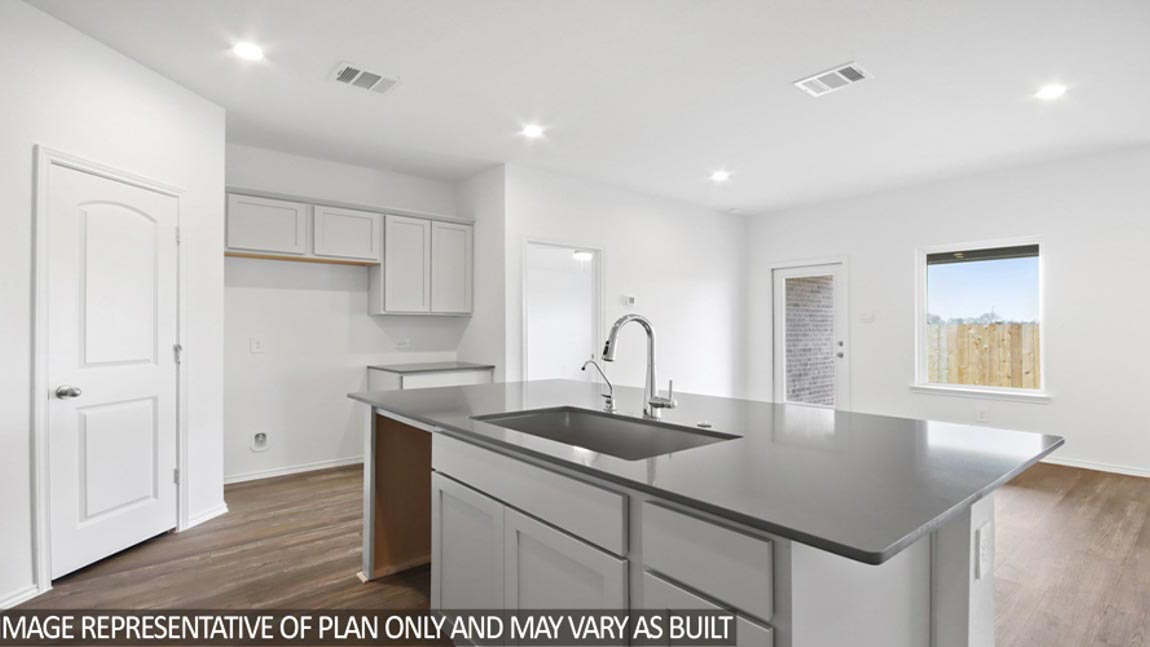 Kitchen with island and a tall pantry.