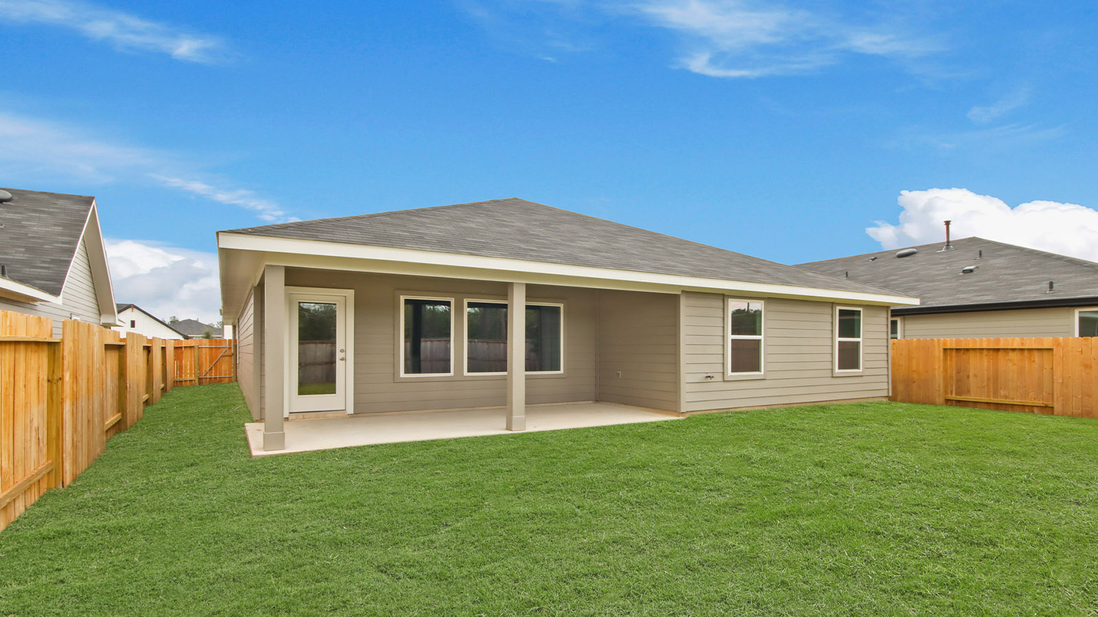 Silverthorne backyard views featuring covered concrete patio with room for seating and grill setup
