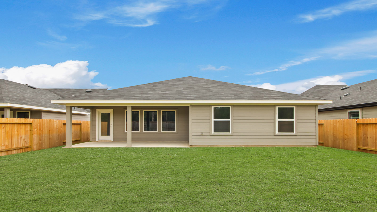 Backyard with covered concrete patio offering seating space, grill setup, and smooth indoor-outdoor transition Silverthorne
