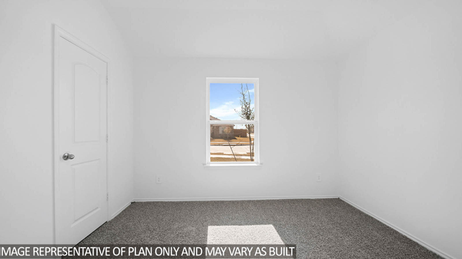 Secondary bedroom with carpet flooring