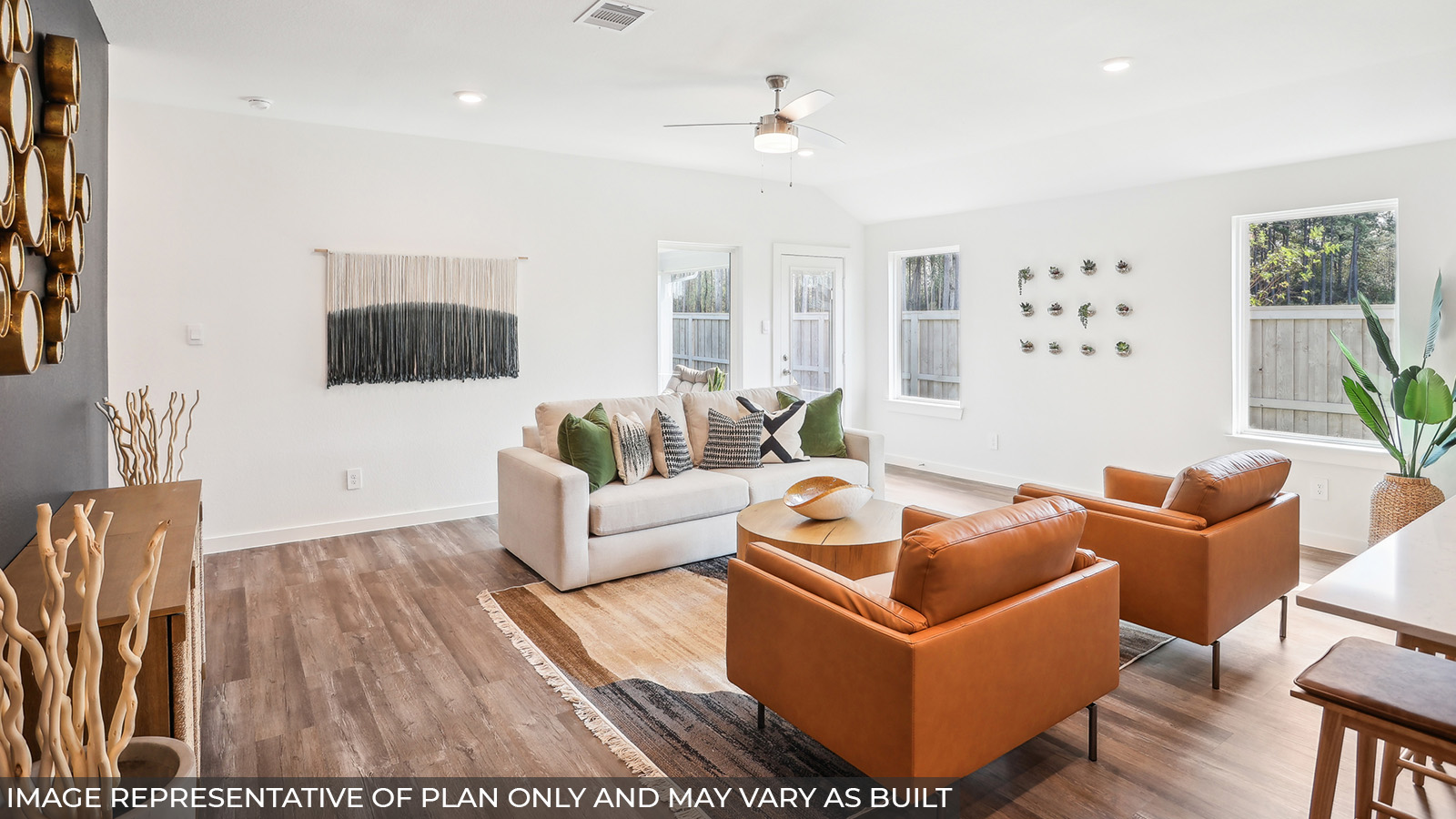 Staged living room with vinyl flooring and bright windows.