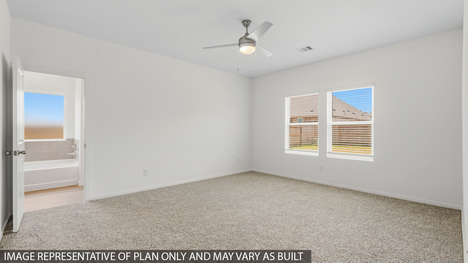 Primary bedroom with carpet flooring
