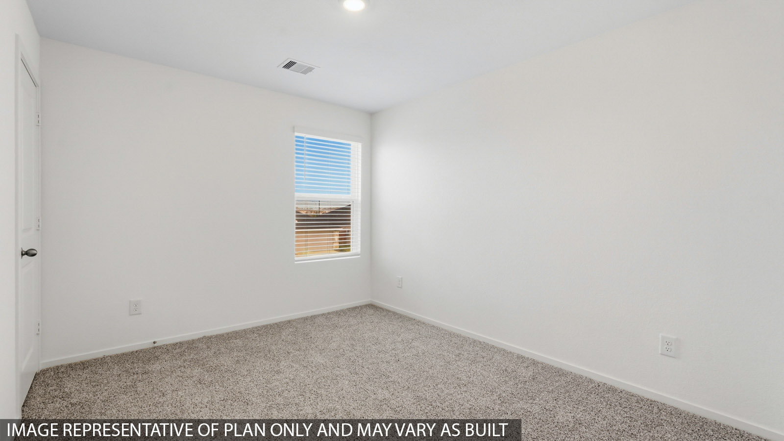 Secondary bedroom with carpet flooring