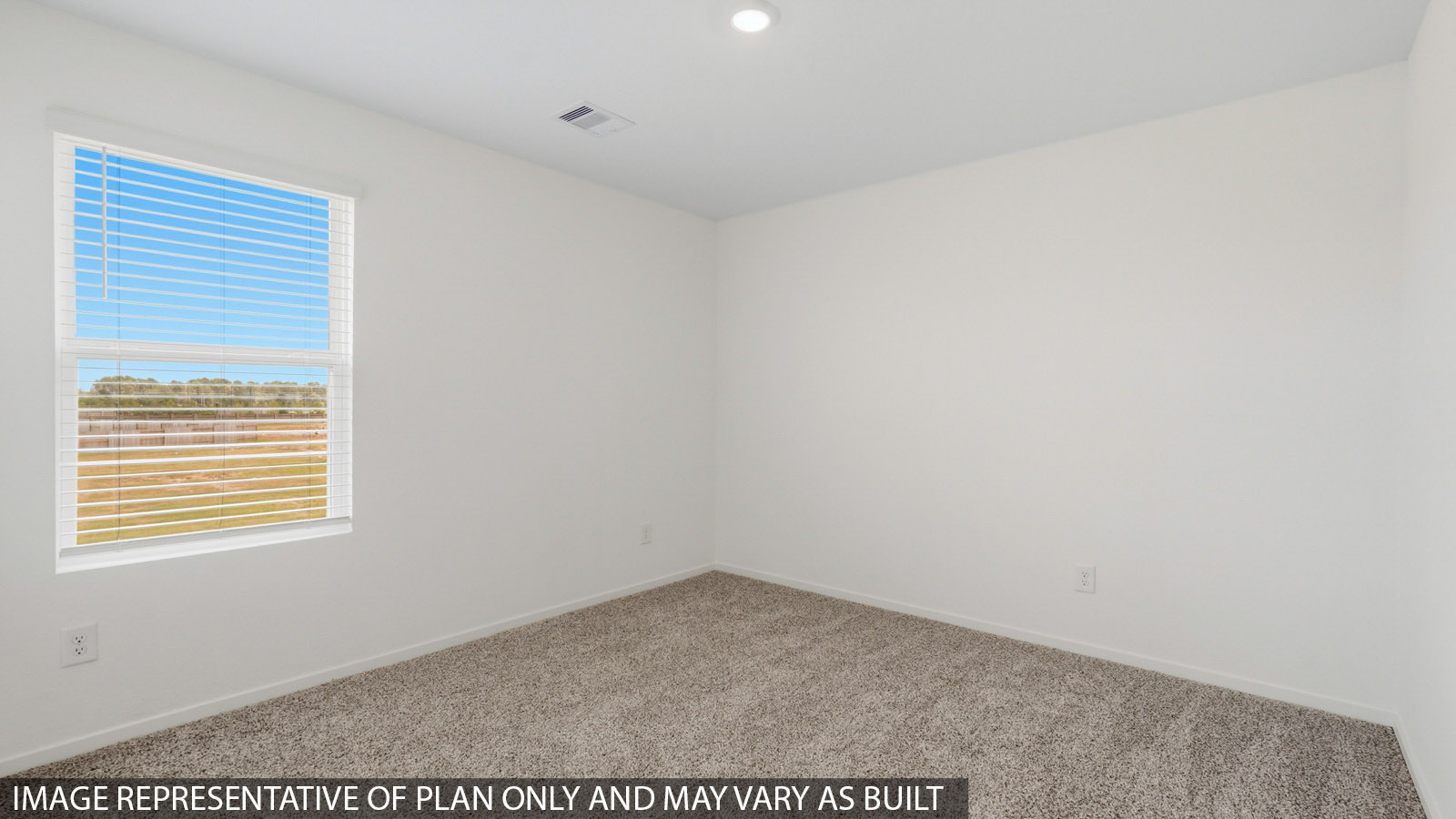 Secondary bedroom with carpet flooring