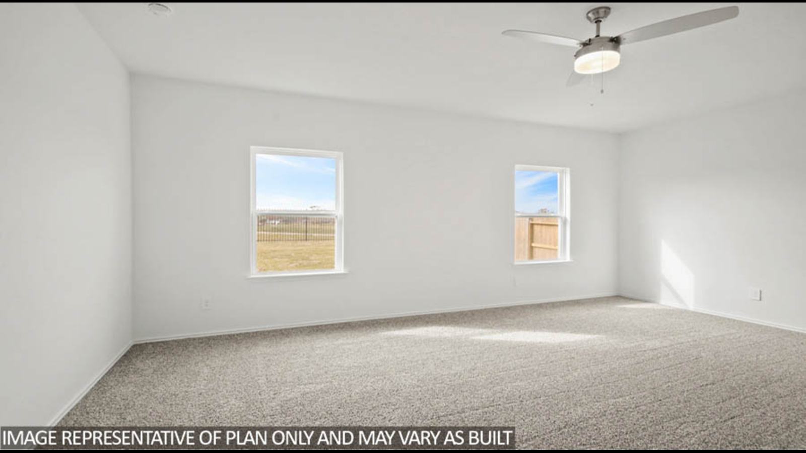 Primary bedroom with bright windows