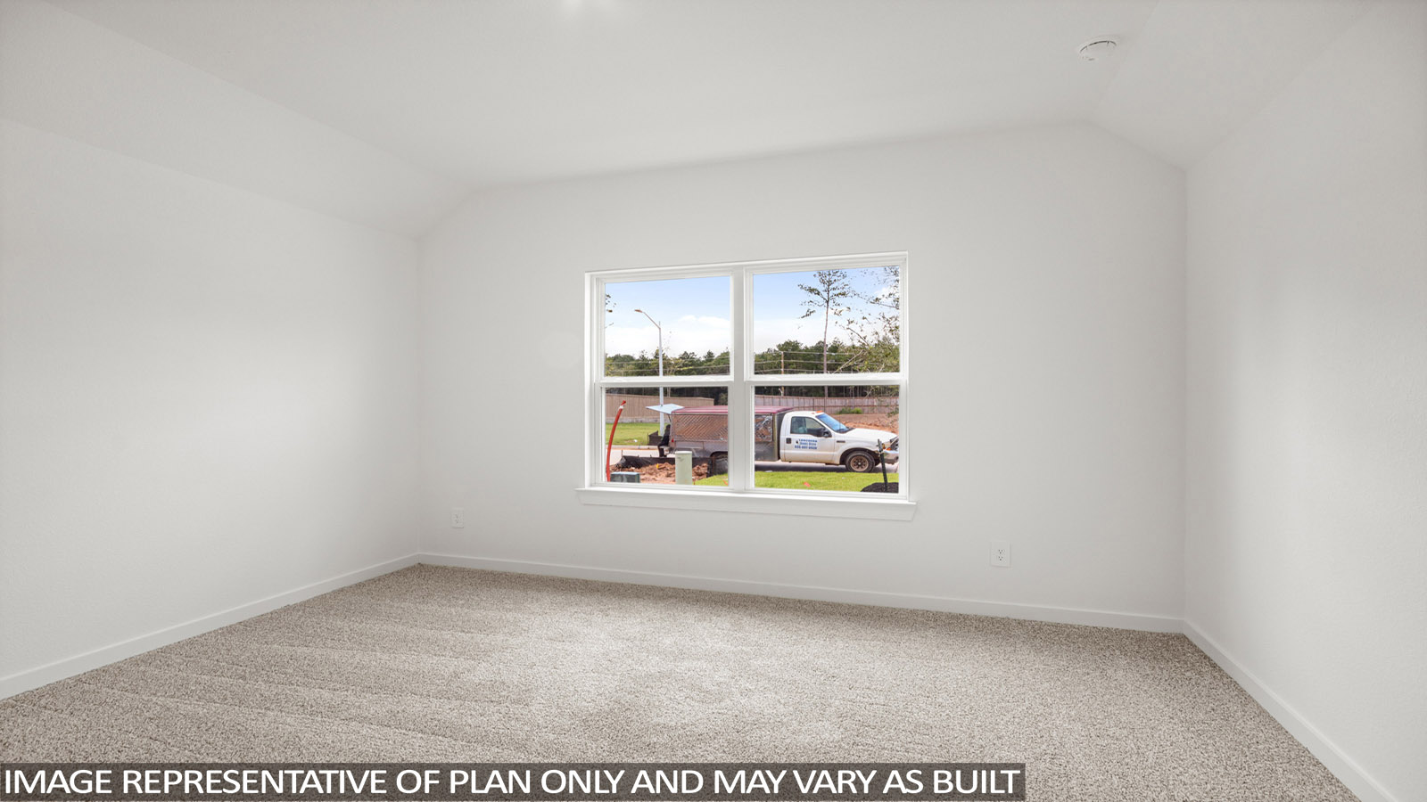 Secondary bedroom with carpet flooring