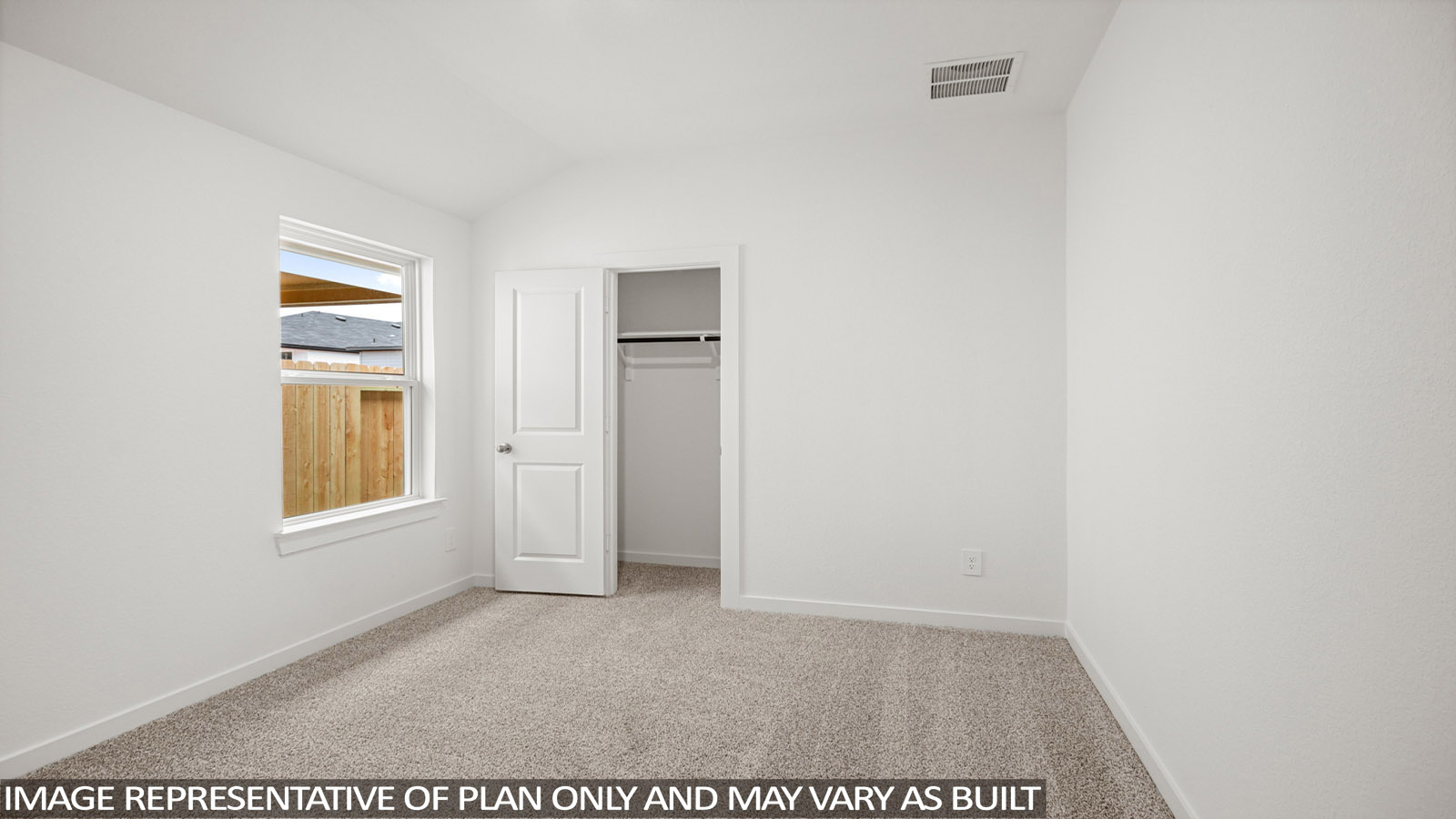 Secondary bedroom with carpet flooring
