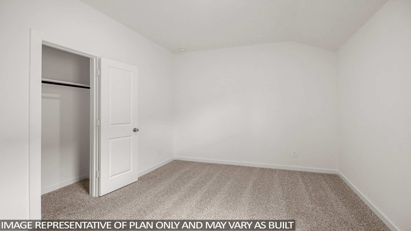 Secondary bedroom with carpet flooring