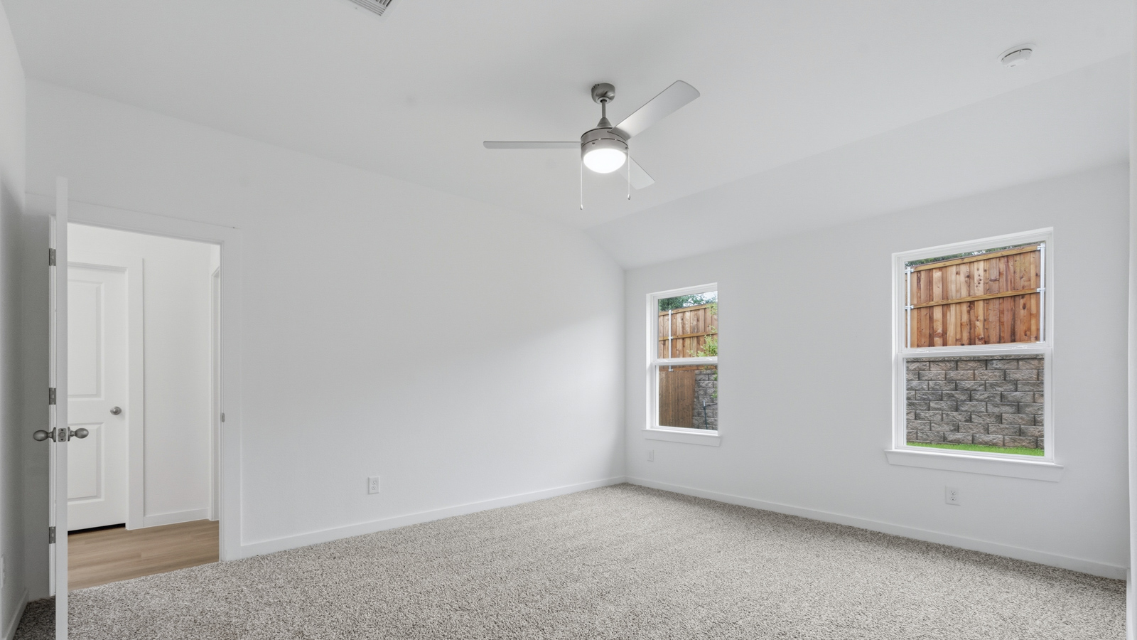 Primary bedroom with carpet flooring
