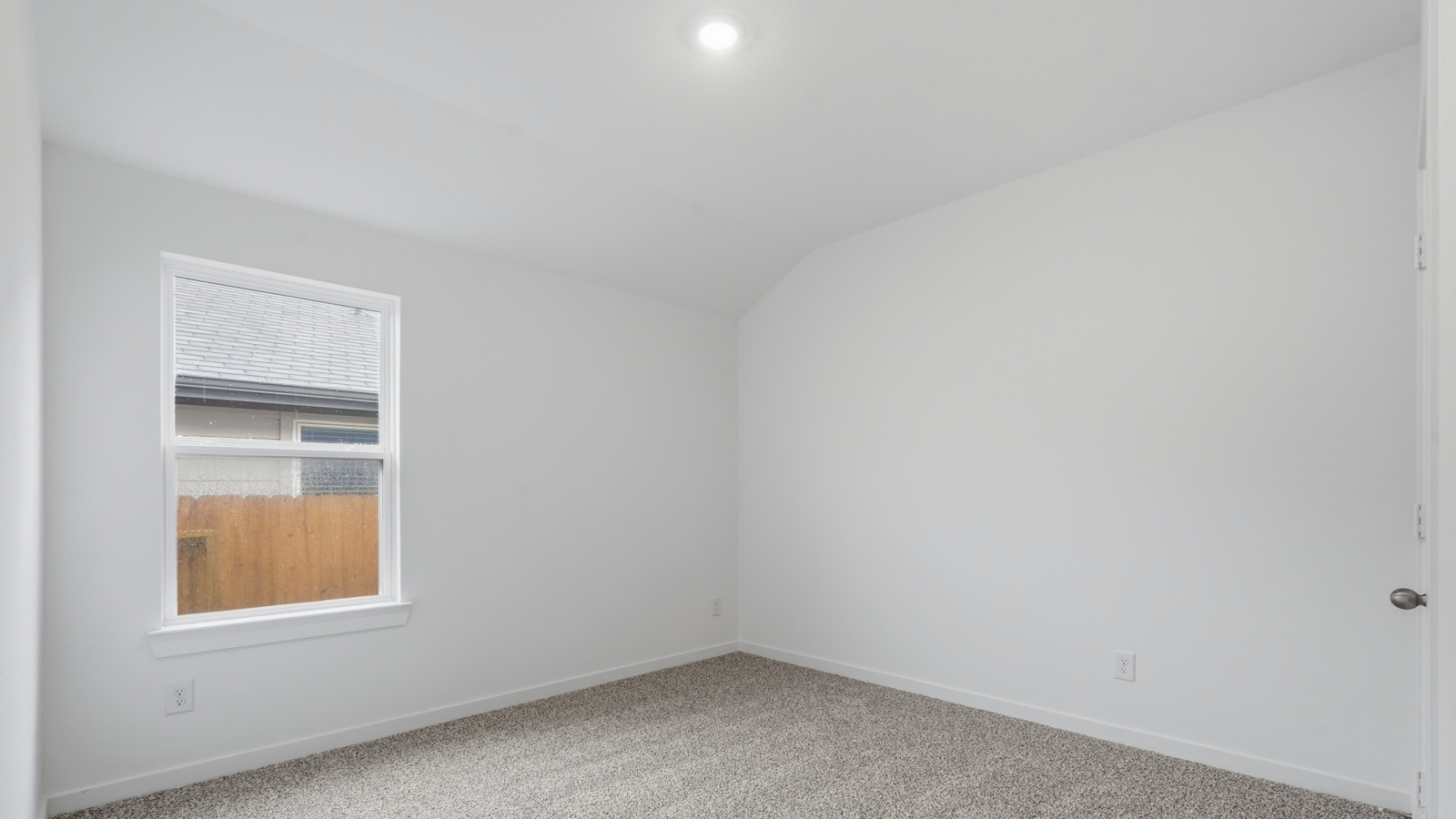 Secondary bedroom with carpet flooring